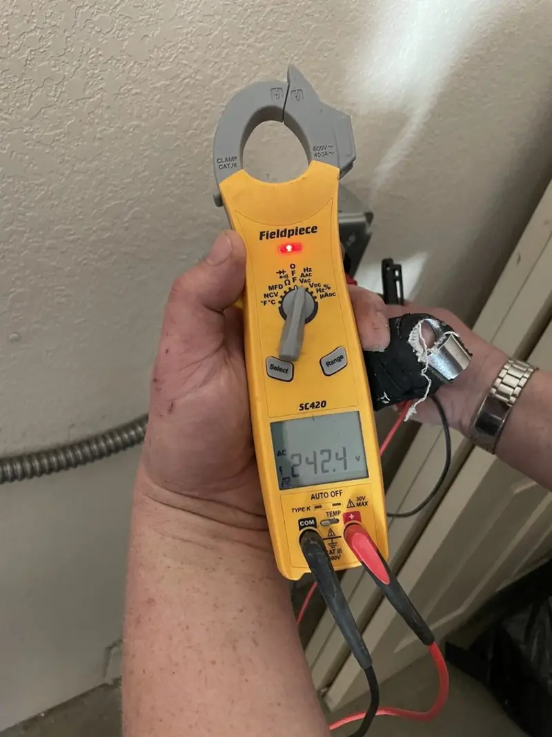 Voltage testing with clamp meter during Electrical Installation Services in Battlefield
